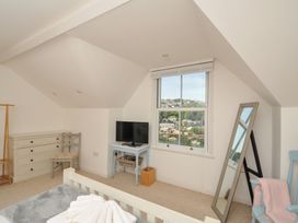 A bedroom with a bed and television at Overdale in Looe