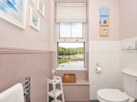 A bathroom featuring a toilet, sink, and window with a view at Overdale in Looe