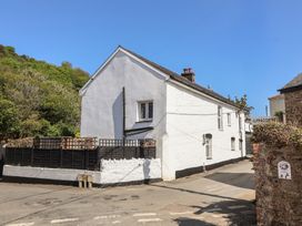 A house with a fence near a road at Honey Cottage Ilfracombe