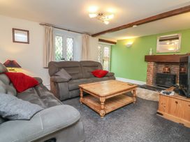 A living room with a sofa and a coffee table at Honey Cottage Ilfracombe
