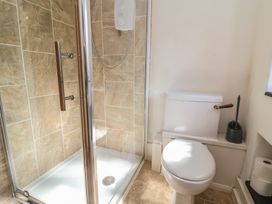 A bathroom with a shower and a toilet at Honey Cottage Ilfracombe