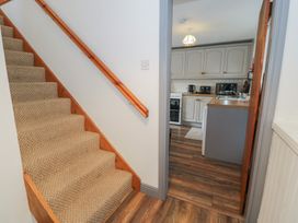 A staircase leading to a kitchen area at Ysgoldy in Dolwyddelan