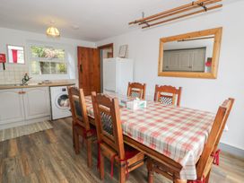 A kitchen with a dining table and chairs at Ysgoldy in Dolwyddelan