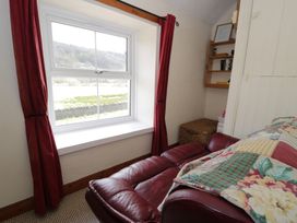 A snug with a window and a sofa at Ysgoldy in Dolwyddelan