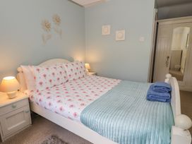 A bedroom with a bed and bedside table at Ysgoldy in Dolwyddelan