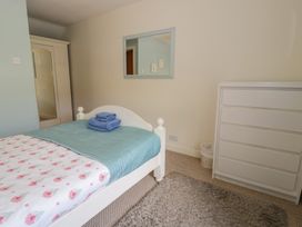 A bedroom with a bed and towels on it at Ysgoldy in Dolwyddelan