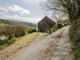 A house with cars parked on a driveway at Ysgoldy in Dolwyddelan