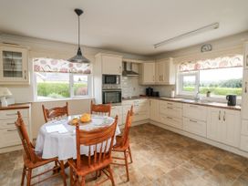 A kitchen with a dining table and chairs at Dunbrody Dreams