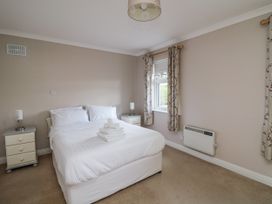 A bedroom with a bed and side tables at Dunbrody Dreams