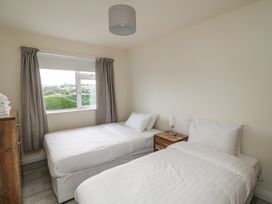 A bedroom with two beds and a nightstand at Dunbrody Dreams