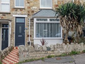 An entrance with a front door and stone wall at Sea Boots in Newquay