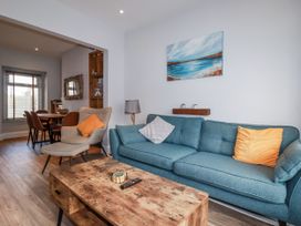 A living room with a sofa and coffee table at Sea Boots in Newquay