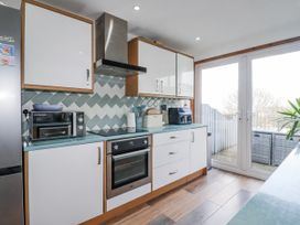 A kitchen with appliances and a view at Sea Boots in Newquay