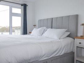 A bedroom with a bed and window at Sea Boots in Newquay