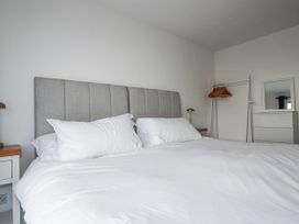 A bedroom with a bed and wardrobe at Sea Boots in Newquay