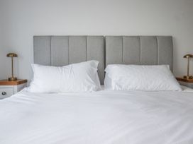 A bedroom with a bed, pillows and lamps at Sea Boots in Newquay