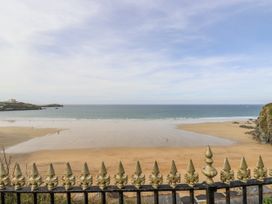 A beach view with a fence and ocean at Sea Boots in Newquay