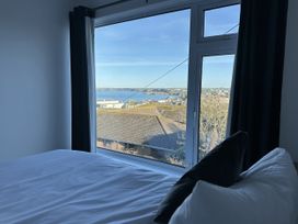 A bedroom with a view of the sea at Sea Boots in Newquay