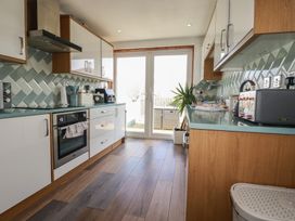 A kitchen with cabinets and appliances at Sea Boots in Newquay