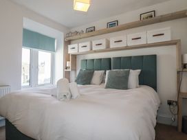 A bedroom with a bed and storage boxes at Sea Boots in Newquay