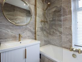 A bathroom with a bathtub and sink at Sea Boots in Newquay