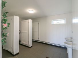 A bathroom with toilet stalls and sinks at Bluebell Lodge in Hastings