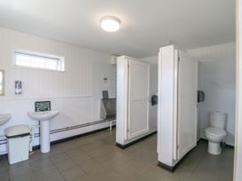 A bathroom with sinks and stalls at Bluebell Lodge in Hastings