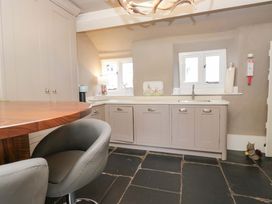 A kitchen with cabinets and a sink at Two Hollens in Ambleside