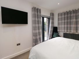 A bedroom with a television and a bed at Two Hollens in Ambleside