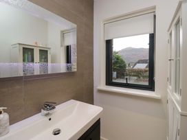 A bathroom with a sink and window at Two Hollens in Ambleside