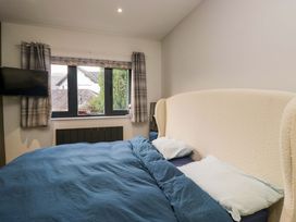 A bedroom with a bed and window at Two Hollens in Ambleside