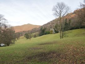 An outdoor area with a house on a hillside at Two Hollens Ambleside