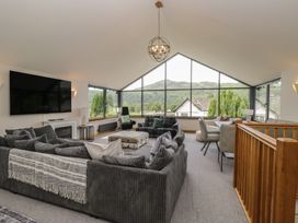 A living room with a sofa and television at Two Hollens in Grasmere