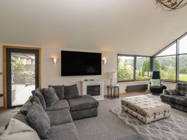 A living room with a television and sofa at Two Hollens in Grasmere