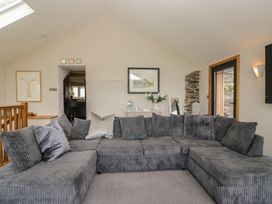 A living room with a sofa and artwork at Two Hollens in Grasmere