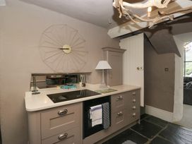 A kitchen with stove and sink at Two Hollens in Grasmere