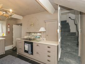 A kitchen with cabinets and stove at Two Hollens in Grasmere