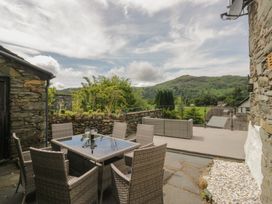 An outdoor dining area with a table and chairs at Two Hollens in Grasmere