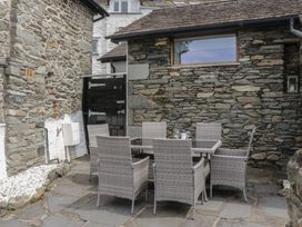 An outdoor dining area with a table and chairs at Two Hollens in Grasmere