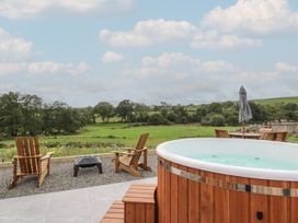 A garden with a hot tub and outdoor seating at Yr Awen in Lampeter