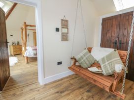 A swing seat and a doorway leading to a bedroom at Yr Awen in Lampeter