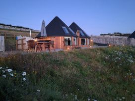 Two houses with a patio area and outdoor seating at Yr Awen Near Lampeter