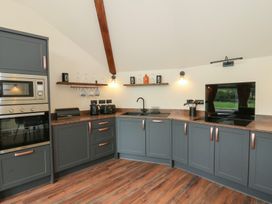 A kitchen with appliances and a sink at Y Cwlwm Lampeter