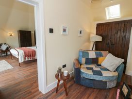 A bedroom with a bed and furniture at Y Cwlwm in Lampeter