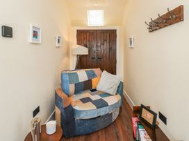 A snug with an armchair and table at Y Cwlwm in Lampeter