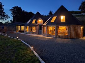 A house with illuminated windows at Y Cwlwm - The Celtic Knot near Lampeter