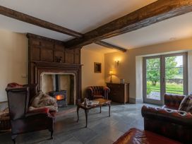 A living room with a fireplace and furniture at Souterstead in Torver near Coniston