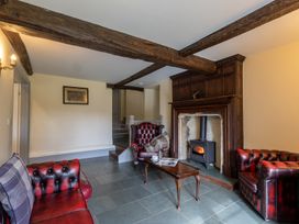 A living room with a fireplace and sofas at Souterstead in Torver near Coniston