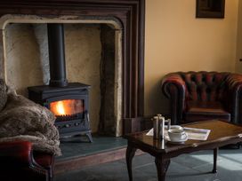 A living room with a fireplace and sofa at Souterstead in Torver near Coniston