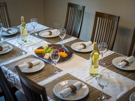 A dining room with a set table and cheese platter at Souterstead in Torver near Coniston